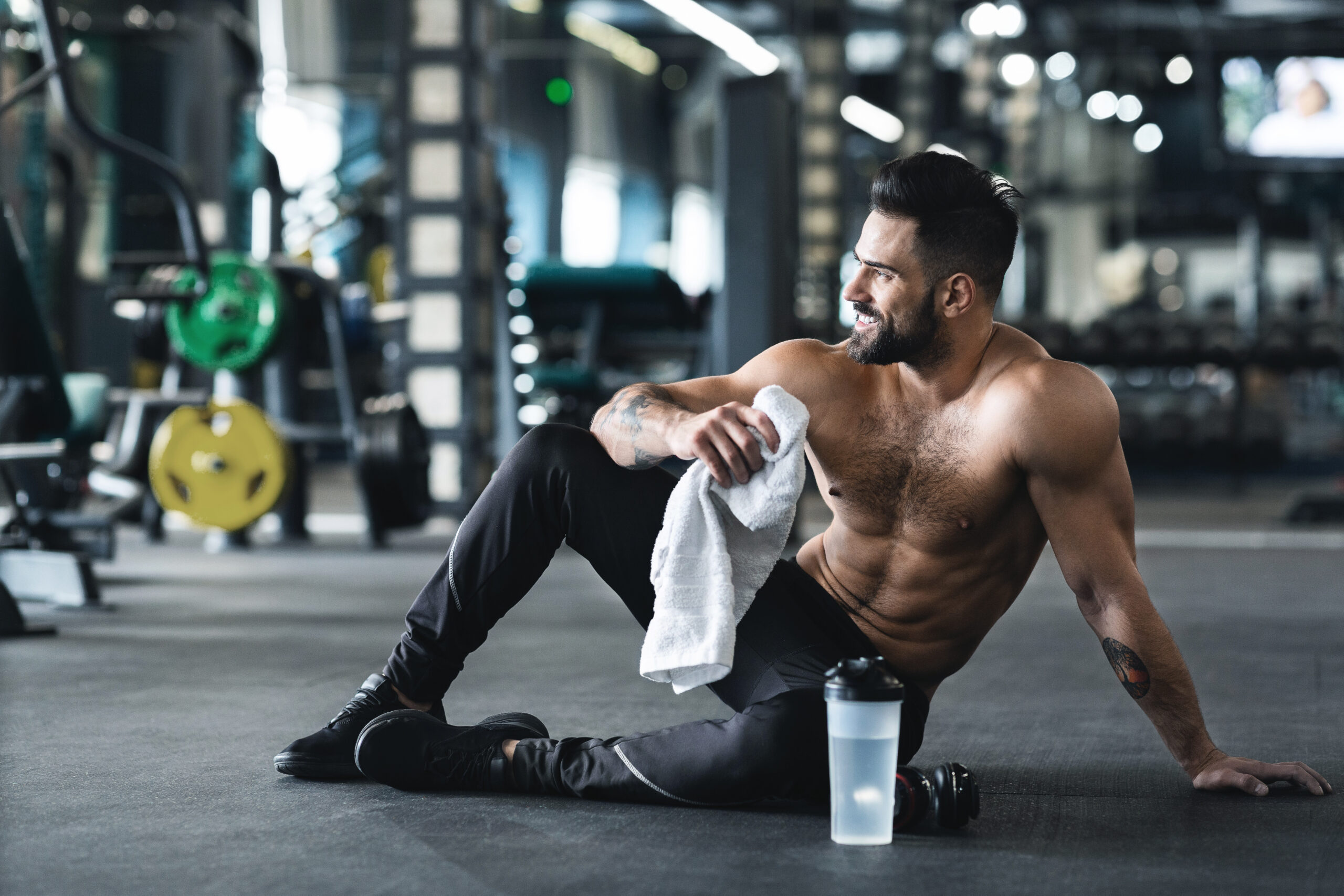 Handsome young sportsman resting after workout