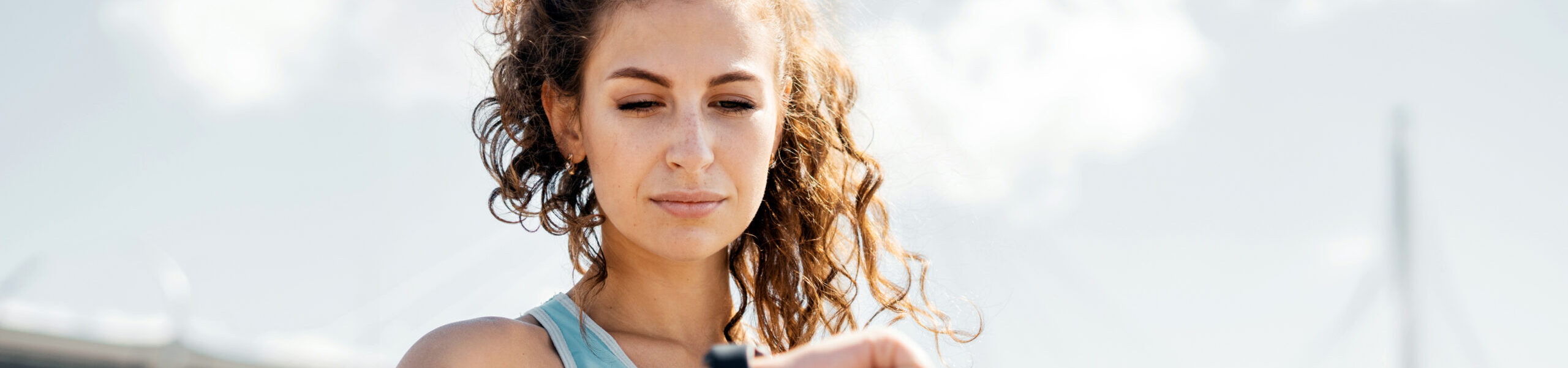 Strong woman checks her smartwatch