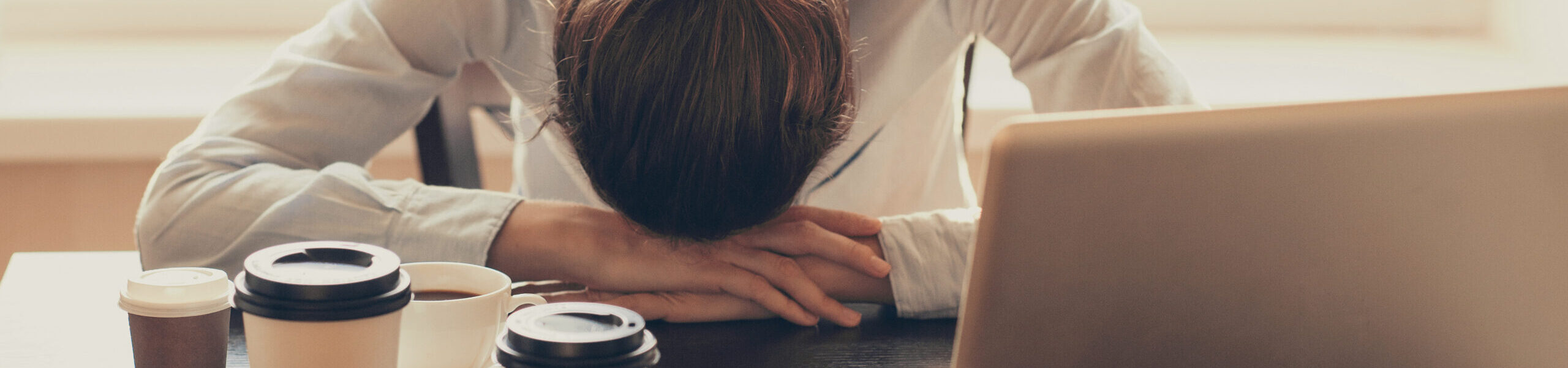 Fatigued woman at her desk