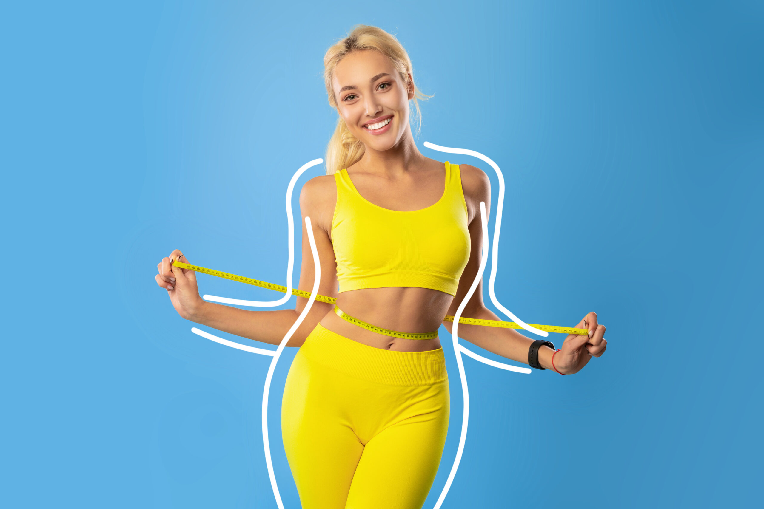 Fit woman measuring waist
