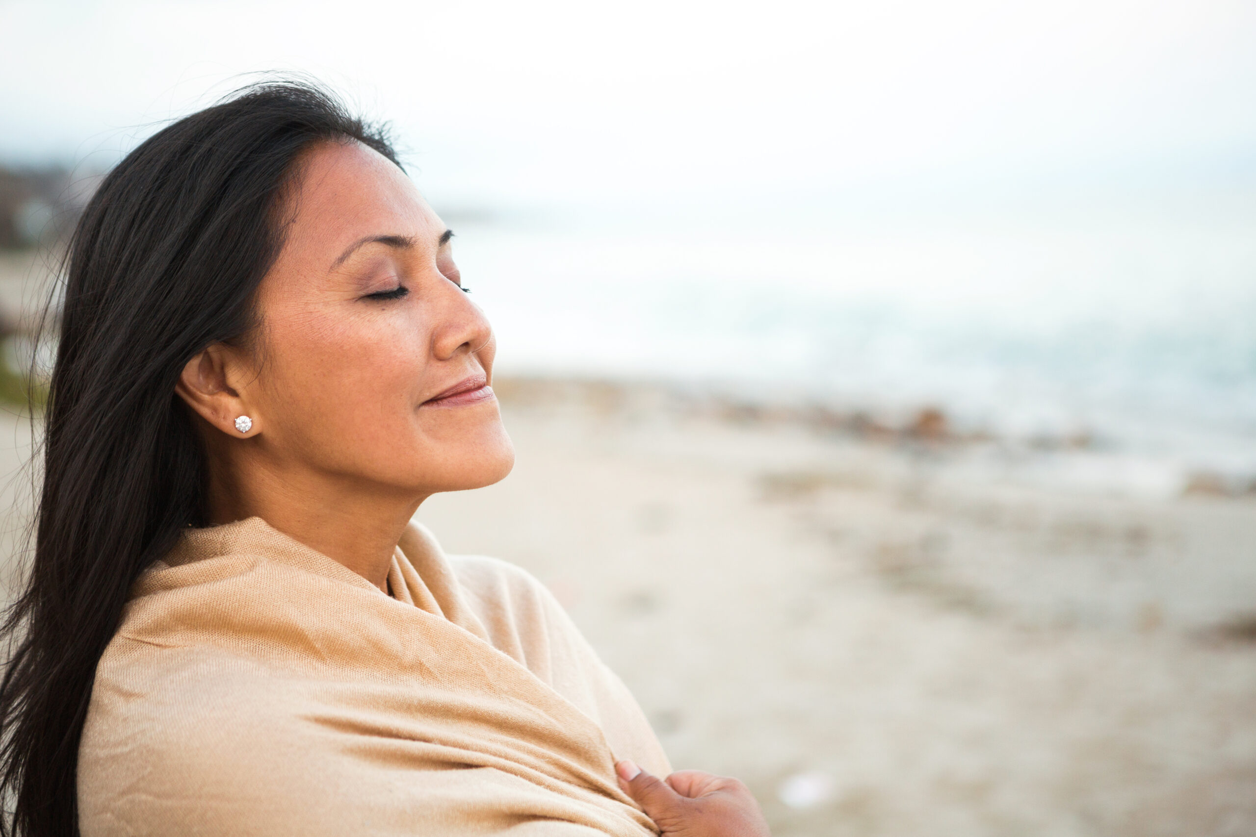 Women relaxing on the beach after Discover how embracing natural hormone replacement therapy prior to perimenopause can help you fend off or delay menopausal symptoms.