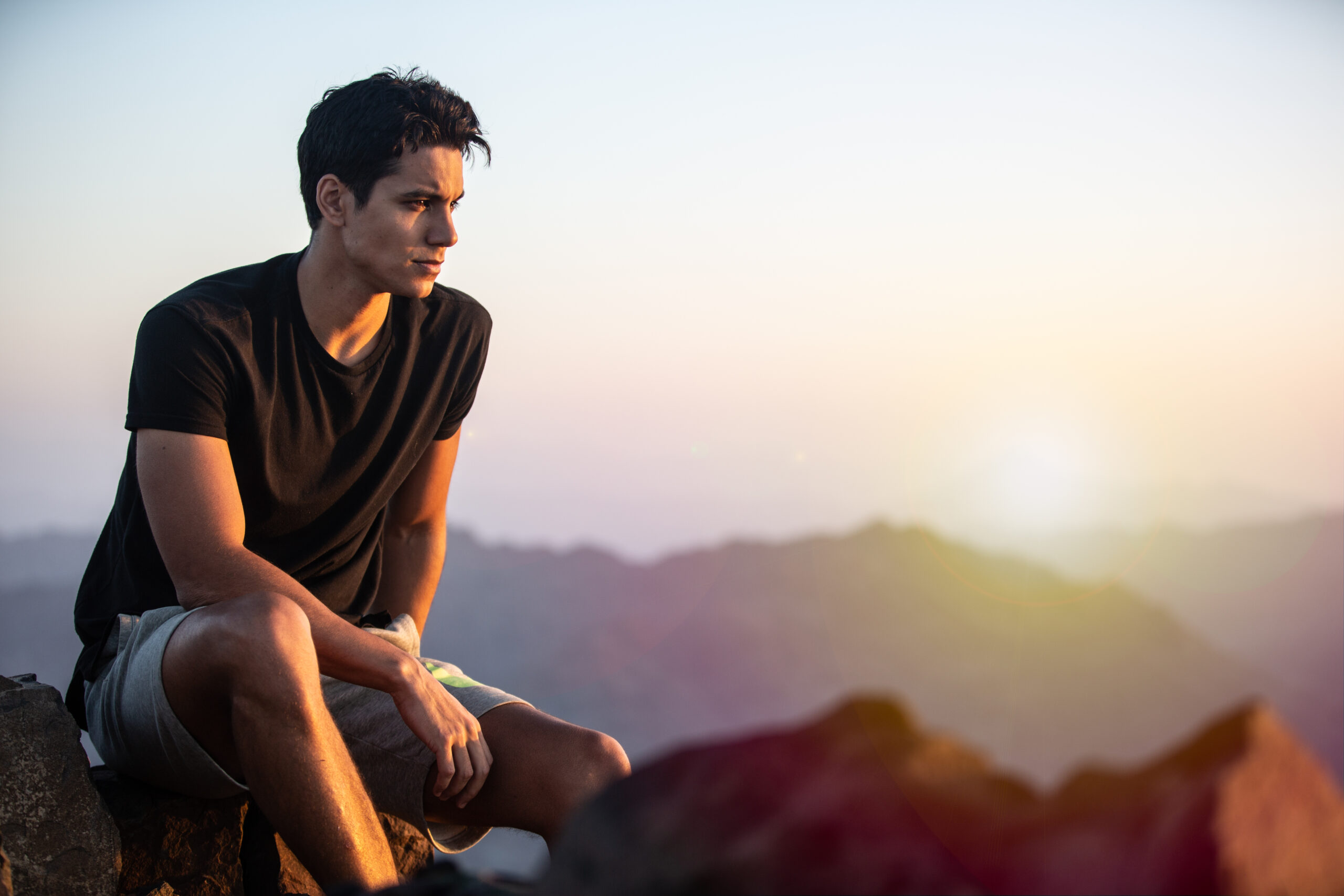 man looking out into the distance of mountains wondering if masturbation effect testosterone levels